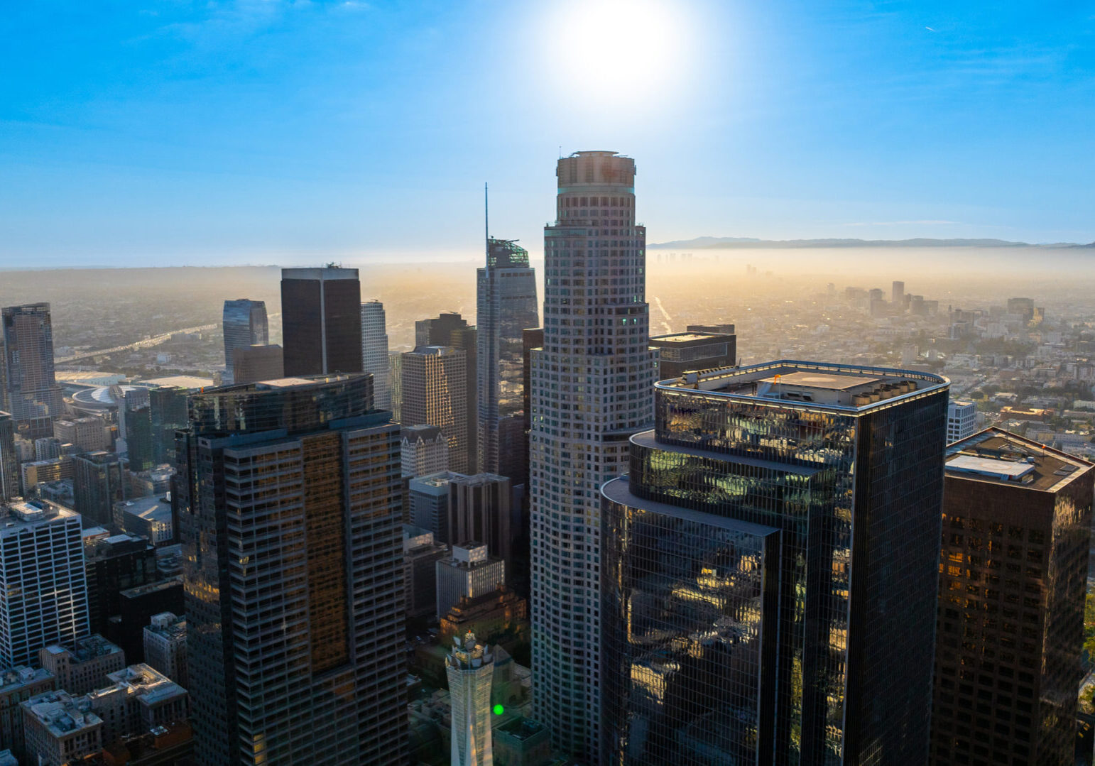 Varied architecture in the downtown of Los Angeles, California, United States. Vast cityscape is dazzled with bright sunlight. Top view.